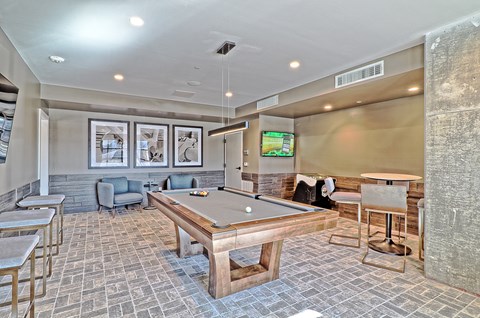 a game room with a pool table and a tv